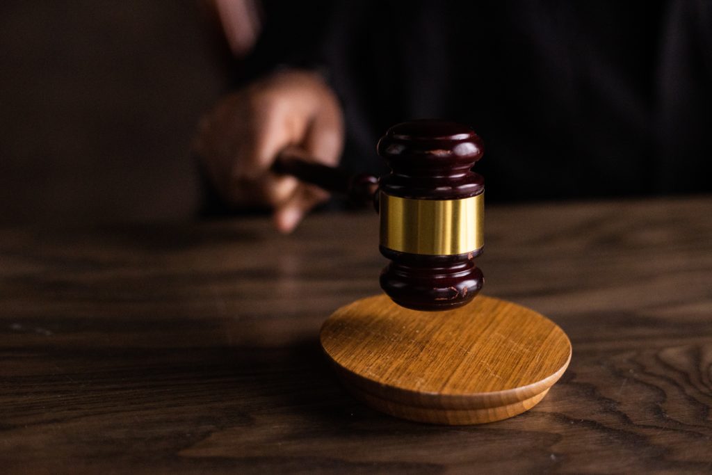 brown wooden gavel and brown wooden table