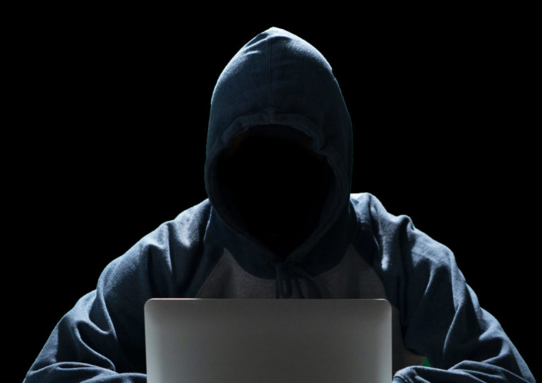 Informant sitting in darkness to hide their identity