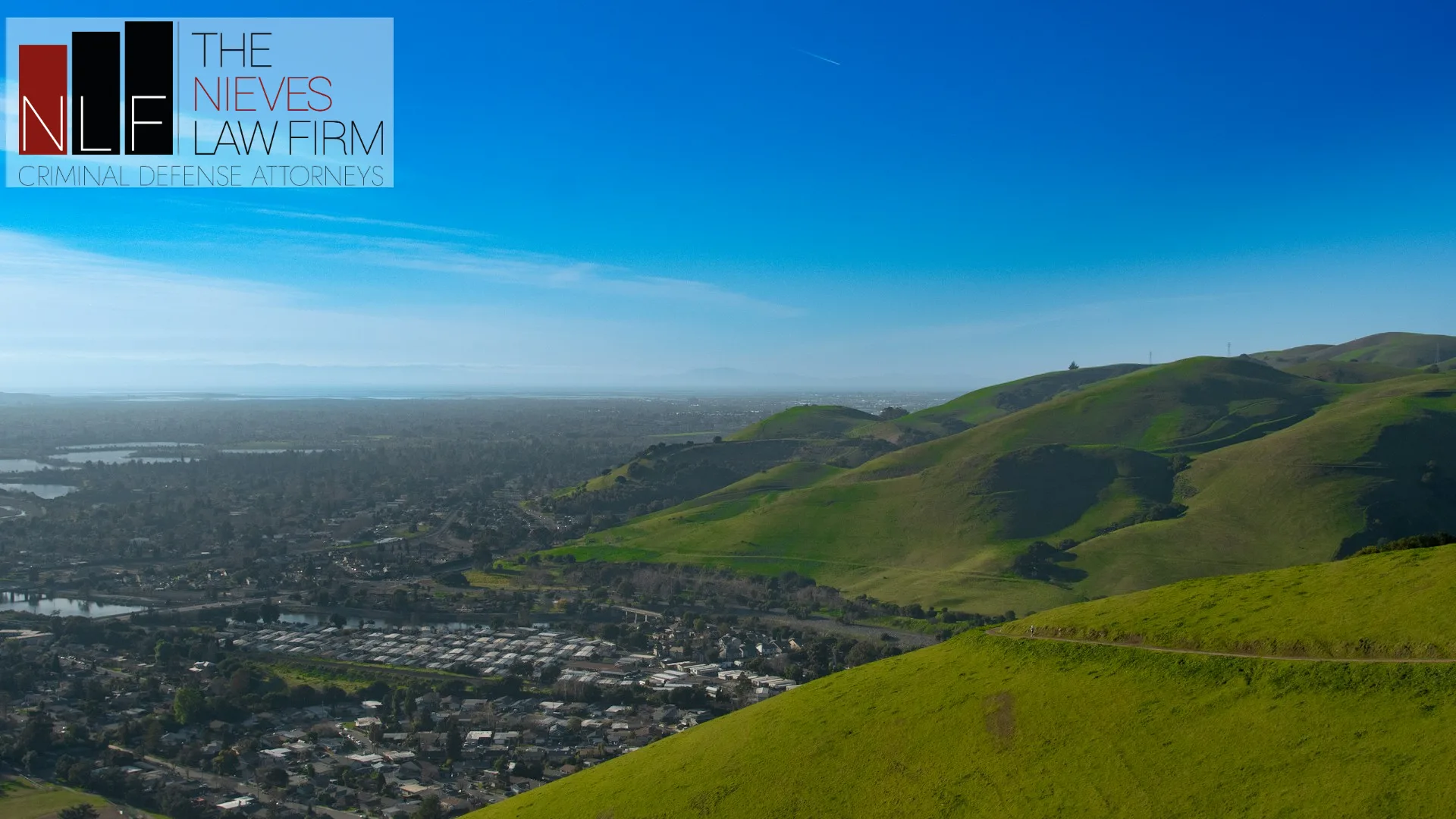 View over Fremont from the green hills of Vargas Plateau, with The Nieves Law Firm logo