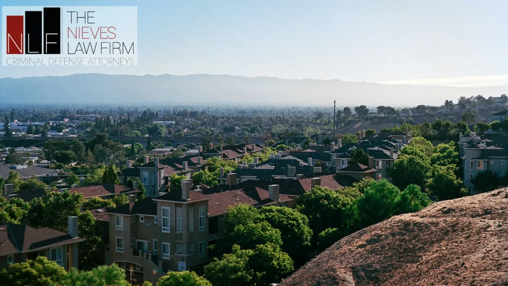 San Jose rooftops and the Santa Clara Valley seen from Communications Hill, with The Nieves Law Firm logo
